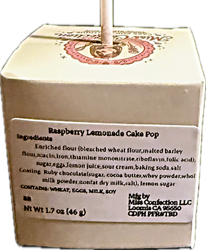 A Miss Confection cake pop box showing the flavor, full ingredient list, allergens and net weight on the label