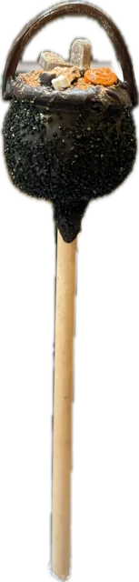 Halloween cake pop decorated as a black witch cauldron with a black licorice handle