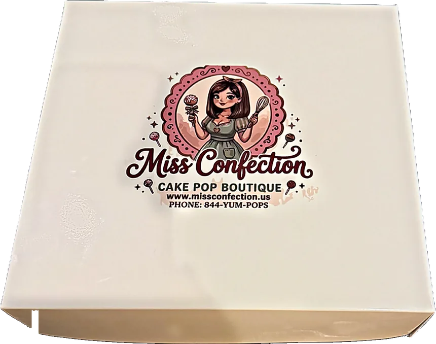 The cream Miss Confection bakery box with the cake pop boutique logo printed on the lid
