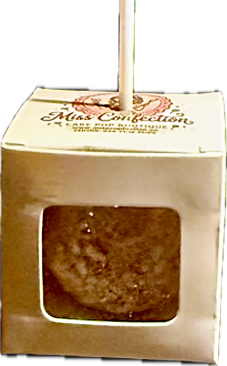 A single cake pop in a small Miss Confection gift box with a clear window in the front